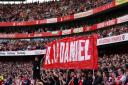 Fans hold up a banner on the 14th minute during Arsenal’s Premier League match against Bournemouth in memory of 14-year-old Daniel Anjorin (Adam Davy/PA)