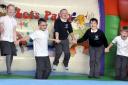 Youngsters enjoy a bouncy castle at Wesley Methodist Primary School, Radcliffe