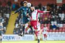 Bury's Nicky Maynard challenges Stevenage defender Scott Cuthbert during Saturday's League Two match