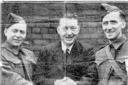 A Canadian handshake between Pte. Dave Smith, Mr. Fred Entwisle and Pte. Tommy Noon