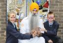 Pupils Emily Kay and Jordan Astley, both aged 11, meet Roop Singh, holding the One God symbol. The children had their faces painted Hindu style