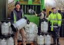 Sales director for WDS Group, Sam Evans, left, and the team crushing and bundling empty KeyKegs