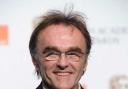 A delighted Danny Boyle with his award for best director