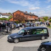 The hearse carrying the body of Dr Saad Al-Dubbaisi passes Garden City Medical Centre in Holcombe Brook, Ramsbottom, Bury, where the doctor worked but had died of Covid-19 at Salford Royal Hospital on Sunday. PA Photo. Picture date: Tuesday May 5, 2020.