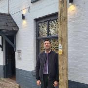 Johnny Gupta, owner of Lime Tree in Prestwich, next to the communications pole