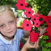 YOUNGSTERS at Unsworth Primary School marked the World War One centenary by creating their own poppy garden. Katie Martin, aged nine, was on hand to help plant the flowers, which pupils created