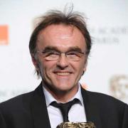 A delighted Danny Boyle with his award for best director