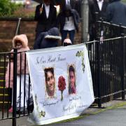 Mourners at Our Lady of Lourdes church, Farnworth for the funeral of cousins Joel Aniyankunju aged 19 and Jason Varghese aged 15.