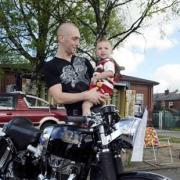 Glen Ratcliffe and Theo Ratcliffe, aged two, with a vintage 1966 Velocette motorbike