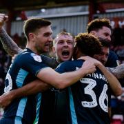 JOY BOYS: Bury players celebrate after Nicky Maynard scored the decisive goal at Exeter