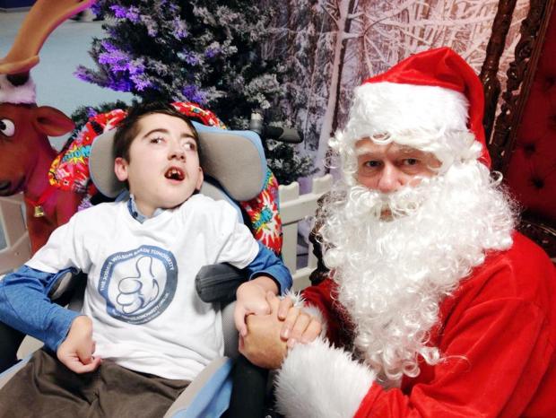 Bury Times: Joshua Wilson pictured at an earlier meeting with Father Christmas