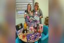 Rachel Krafft, community fundraiser (left), and Joanne Johnson, volunteer services coordinator, with some of the items available at the Christmas fair