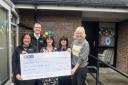 From left; Louise Grantham and Jack Studholme from REPIC present the donation to staff at Bury Cancer Support Centre
