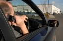 PICTURE POSED BY MODEL. File photo dated 14/02/2007 of a driver talking on his mobile telephone while driving. Sightings of handheld mobile phone use by drivers are common on UK roads despite Friday being the 20th anniversary of the practice being