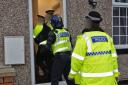 Police raid a home in Bury