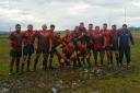 A muddied Bury Broncos side celebrate going top of NWML Division Two following a 17-0 victory at Rochdale Mayfield A