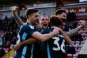 JOY BOYS: Bury players celebrate after Nicky Maynard scored the decisive goal at Exeter