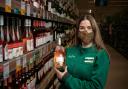 Kylie Collins, who works at Morrisons, with a bottle of Kylie Minogue's new range of rose wine stocked at the supermarket chain