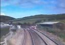 Watch the terrifying moment driver nearly collides with train at level crossing
