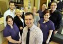 EXCELLENCE: Dr Michael Cahill, centre, with staff at Cahill Dental Centre, Higher Bridge Street, Bolton