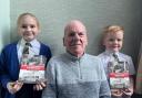 David Barrow with grandchildren Elouise and Stanley and copies of his new book
