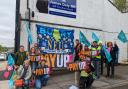 NEU members gather outside MP James Daly's Bury office on Tuesday