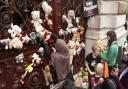 Parents and children lay cuddly toys across the entrance to the Foreign Office in London