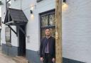 Johnny Gupta, owner of Lime Tree in Prestwich, next to the communications pole