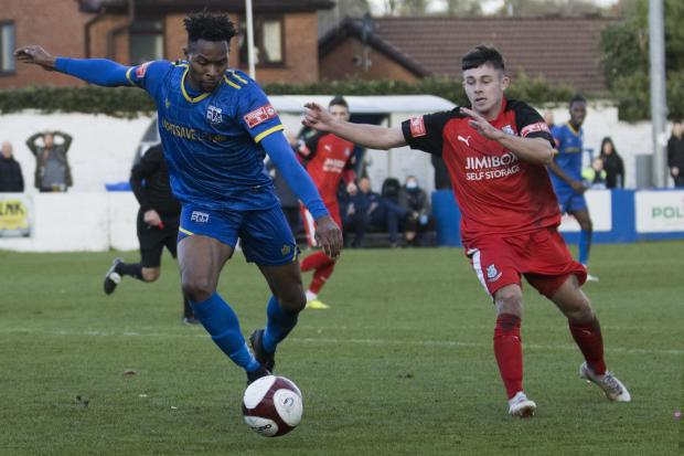 OPENER: Jean Louis Akpa-Akpro left in action against Bamber Bridge) set up the Trophy triumph. Picture by Hayden Roberts