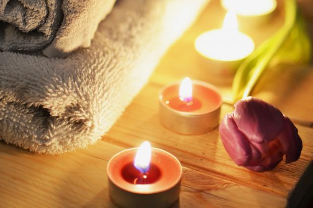 Bury Times: A pile of towels, candles and a tulip. Credit: Canva