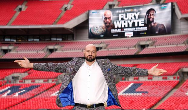Bury Times: Tyson Fury poses on the pitch after the press conference at Wembley Stadium, London (PA)