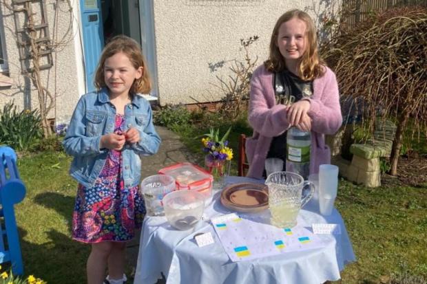 Bury Times: Christina and her little sister Hayley at their stall raising money for Newsquest's Ukraine appeal.
