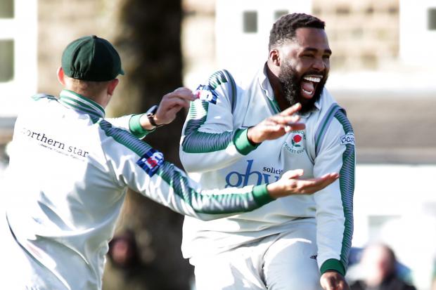 JOY: Greenmount’s Chesney Hughes celebrates taking a Ramsbottom wicket. Picture by Harry McGuire