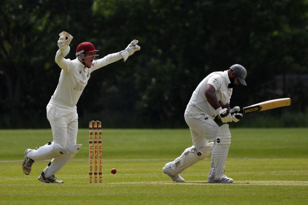 CELEBRATION: Bury wicketkeeper Nathan Ramsay after the dismissal of Greenfield pro Ashar Zaidi. Picture by Eddie Garvey