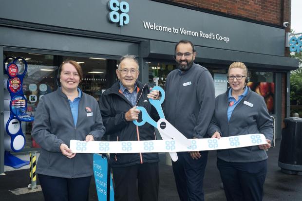 Staff at the Co-op and a customer at the unveiling of the refurbished store