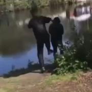 A still from the shocking video, which shows a 74-year-old man being kicked into the Mersey near Riverside Retail Park