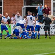 PILE ON: Bury AFC celebrate a goal in the 2-1 win against North Shields Picture: Phil Hill