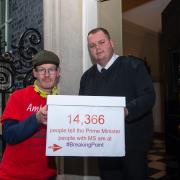 Vince Ashton, 51, left, hands a petition at Downing Street
