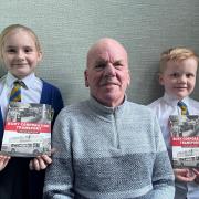 David Barrow with grandchildren Elouise and Stanley and copies of his new book