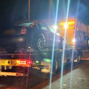 A car being seized on Dumers Lane in Radcliffe