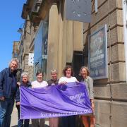 From left; Two members of the Street Pastor team, Jill Youlton, Victoria Robinson, Cllr Charlotte Morris and chief executive Lynne Ridsdale holding the Purple Flag outside The Met in Bury