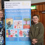 Chief Executive Lynne Ridsdale with Bury's Youth Mayor, Family Safeguarding Banner inbetween them displaying children's artwork