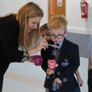 Sara Yates helping Bury Grammar School primary pupils with fun 'learning to breath' activities during her visit