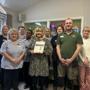 Staff members with a certificate following the inspection