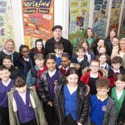 Lee Crocker with children who contributed to the artwork