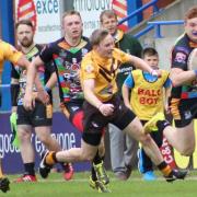 Bury Broncos A, in the black and gold, do their best to keep out Rochdale Cobras at Spotland
