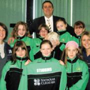 Kitted out: Estate agent Nicholas Clegg with teachers Julie Mannion and Laura Taylor and pupils Bethan Madeley, Chloe Law, Leah Hand, Jenna Holt, Sarah Unsworth, Emma Almond and Cara Newton-Ridyard