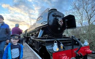 Edward Almond, three, is following in his great-granddad's footsteps, waving in the Flying Scotsman at Ramsbottom station