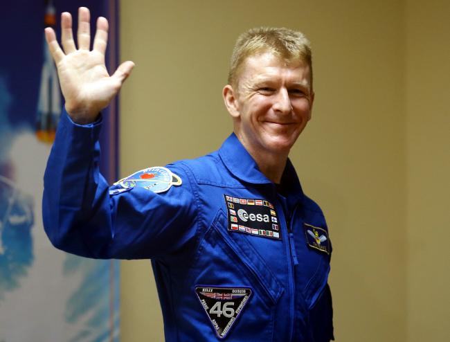 British astronaut Tim Peake waves as he leaves the crew's news conference at the Cosmonaut Hotel in Baikonur, Kazakhstan, ahead of his launch to the International Space Station on Tuesday. Picture date: Monday December 14, 2015. See PA story SCIENCE Peake